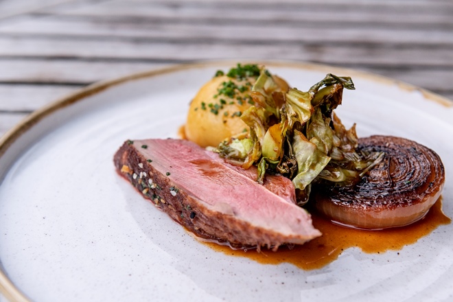 Duck with sauerkraut potato dumplings and hispi cabbage